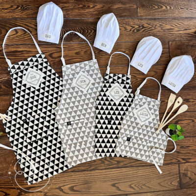 Unique personalised quality aprons matching for all the family with head chef sous chef tags and chef hats and wooden tools